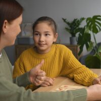 medium-shot-woman-girl-playing-memory-game (1)